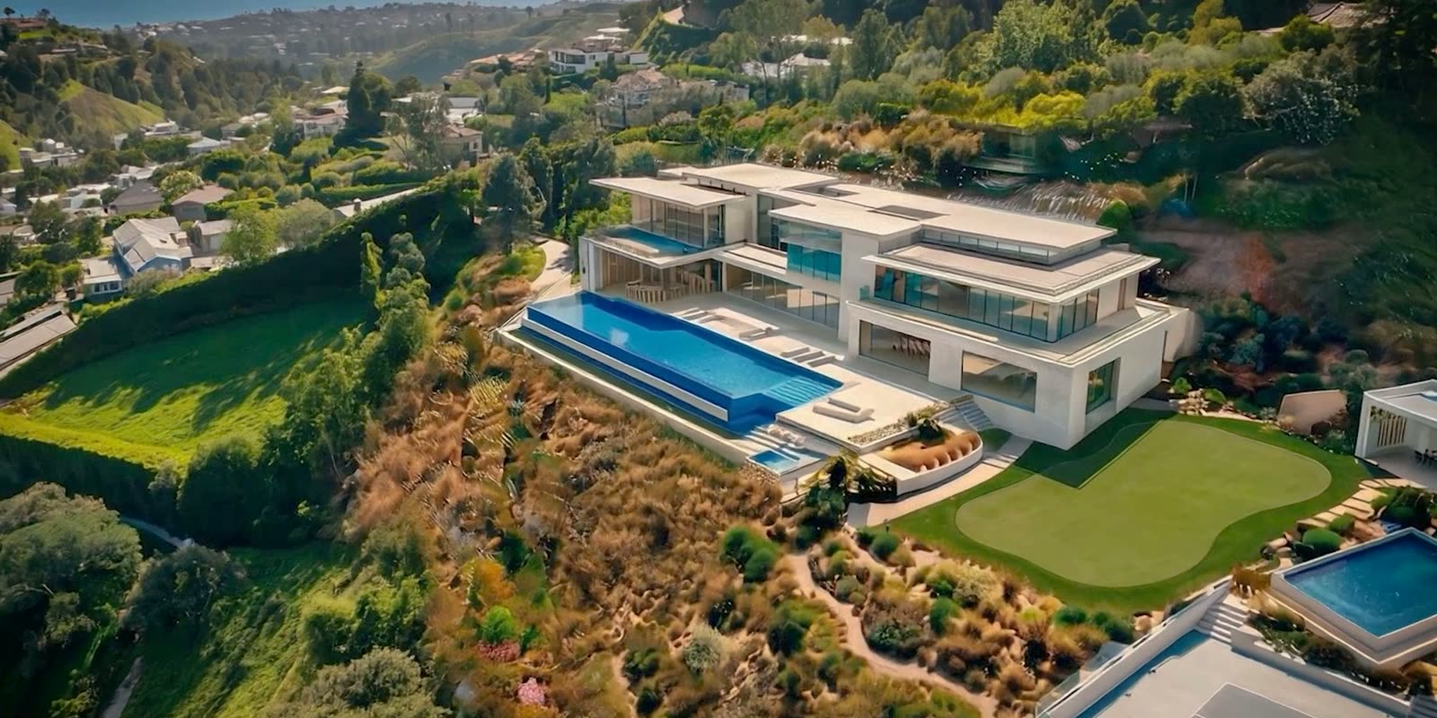 Aerial rendering of a modern estate stepped into the hillside with an infinity pool, lawn and tennis court