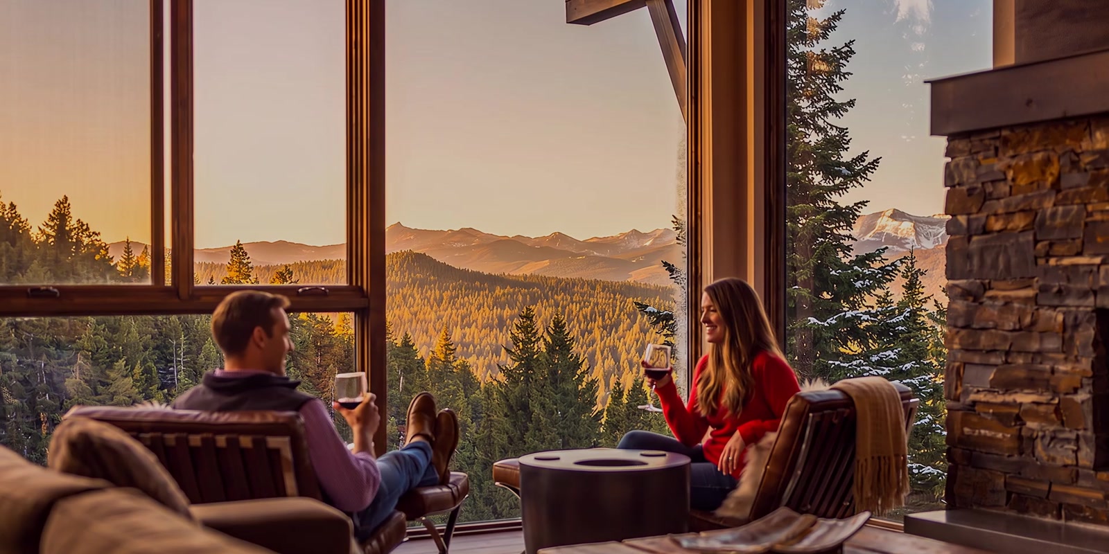 An AI visualization of a couple sharing wine beside tall windows overlooking the mountains at sunset