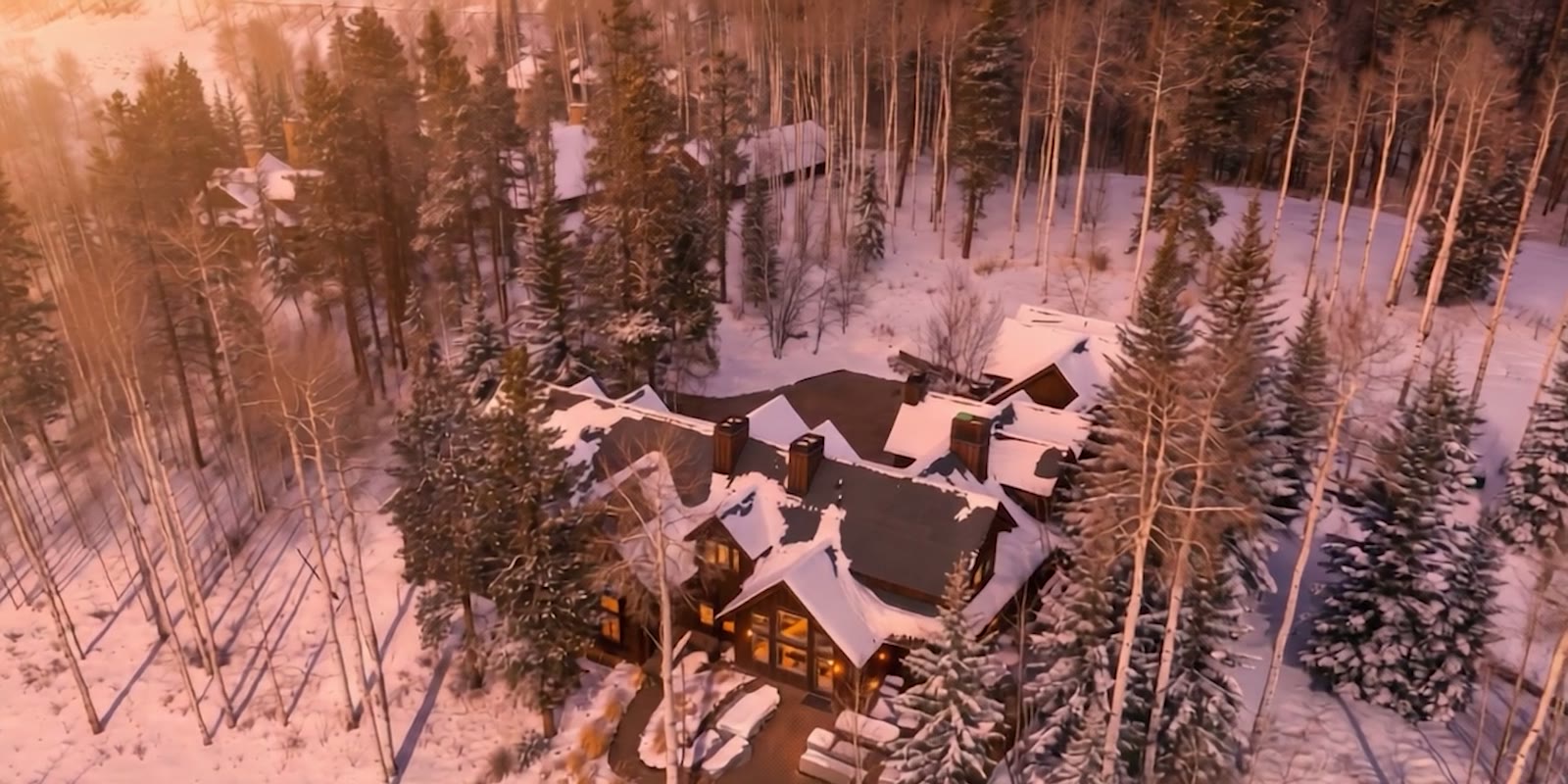 An AI visualization of a mountain home surrounded by snow-covered forest in warm evening light